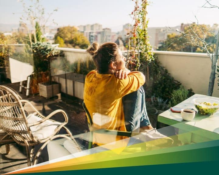 Young woman is sunbathing on the balcony